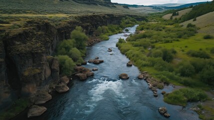 Aerial View Of Serene River Valley Lush Greenery Dark Cliffs