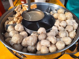 Traditional Indonesian meatballs jumbo big size snacks fast food bakso cook soup. Bakso, meatball soup with tofu, dumplings, and fried food. Indonesian cuisine.