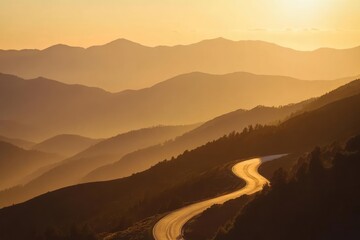 Obraz premium a winding mountain road at sunset golden light filtering through misty peaks
