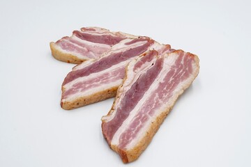 Pieces of salted lard with layers of meat on a white background. Sliced ​​bacon.