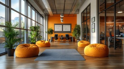 A large open office space with orange bean bags and a green plant