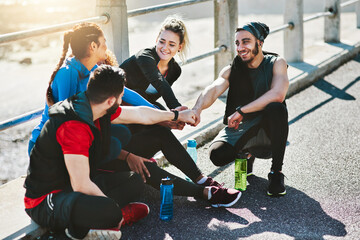 Fototapeta premium Fist bump, sports and group of people outdoor with running for workout, health or wellness. Bonding, fitness and athletes with motivation for cardio exercise for race or marathon in solidarity.