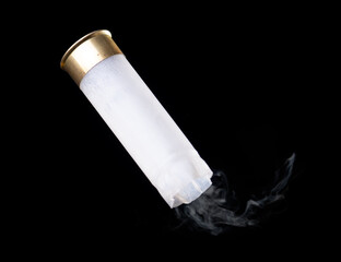 White shotgun shell with smoke flying through the air on black