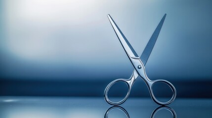 A minimalist shot of silver scissors standing upright on their tips on a reflective glass surface, with a blurred background.