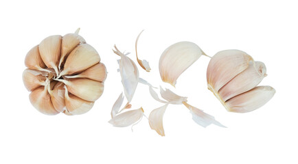 garlic with onion peel scattered isolated on white background