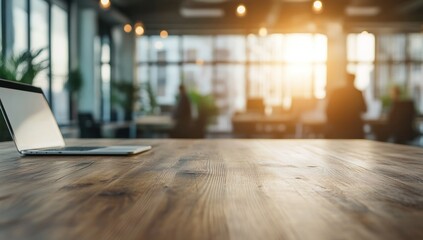 Obraz premium Laptop on Wooden Desk in Modern Office with Blurred Background