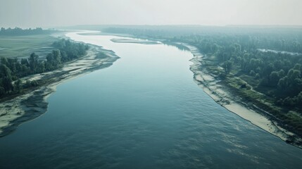 River meandering through misty landscape; aerial view