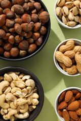 Various nuts in white and black bowls