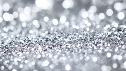 A beautifully textured luminous background, featuring radiant bokeh highlights and glistening silver dust
