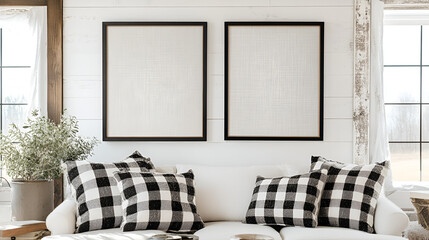 Farmhouse Living Room Mockup: Two blank black framed canvases hang above a cozy white sofa adorned with black and white buffalo check throw pillows, set against a rustic white shiplap wall.