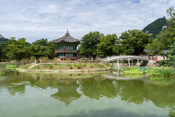 Fototapeta premium Picturesque pavilion nestled in Gyeongbokgung Palace's serene Hyangwonjeong Garden, Seoul, South Korea.