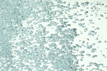 Many water bubbles on light background, closeup