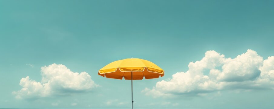 Sunny Day Paradise: Yellow Beach Umbrella Under a Blue Sky