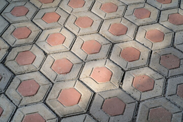 Textural backgrounds hexagonal paving blocks. Hexagonal bricks for flooring exposed to morning...