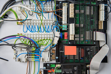 Close-up view of wiring system and circuit board inside electrical control panel. Electrical components used for automation and regulation of various systems