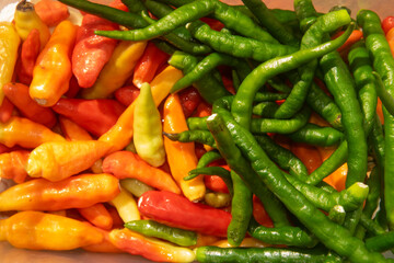 a bunch of green chilies and red chilies