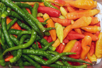 a bunch of green chilies and red chilies