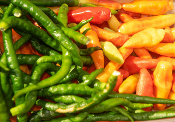a bunch of green chilies and red chilies