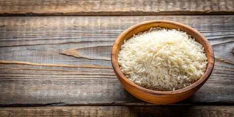 White Round Wooden Bowl with Uncooked Rice on White Background