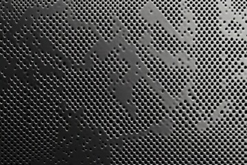 perforated metal surface detailed close-up monochrome design with intricate patterns and soft shadows