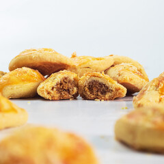 Indonesian nastar snack with pineapple jam filling. Assorted pastries with golden crusts and sweet cinnamon filling are beautifully displayed. The aroma of freshly baked goods fills the air