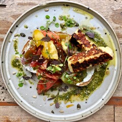 A beautifully presented meal and a refreshing beverage served at a modern restaurant, showcasing the rich flavors and vibrant dining culture