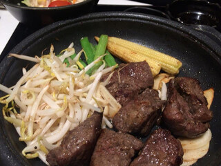 Japanese teppanyaki steak with bean sprout, green bean and baby corn in hot iron plate