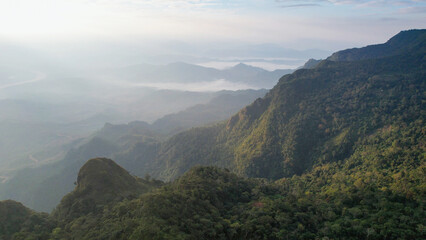 Naklejka premium Aerial landscape view of the mountain range on foggy day by drone