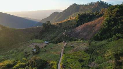 Aerial view from drone of rural village and mountain road