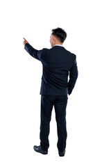 Portrait rear view of Asian businessman standing with confidence while pointing something isolated over white background. Copy space. Concept of business, entrepreneur, and successful