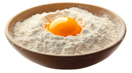 Egg yolk lies in flour on wooden bowl, ready for baking and cooking