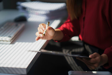Businesswoman working with tablet and pen in modern office