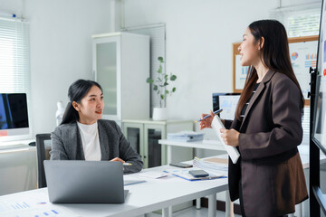 Asian businesswomen discussing and working together in modern office