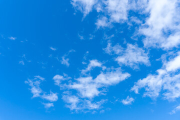 Low angle view and full frame of beautiful blue sky with strange shape of fluffy white clouds in the morning or evening on sunny day used as natural background texture in decorative art work