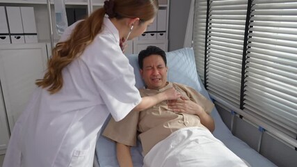Asian female doctor examine patient man lying on bed in recovery room. 