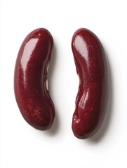 Two kidney beans isolated on a white background showing their smooth texture and deep color