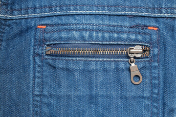 Blue jeans jacket pocket with classic zipper.Brown metal zipper.Clothing industry concept.For graphic design or banner background.