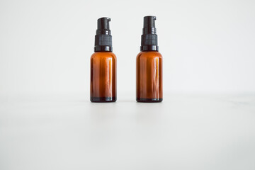 eye serum moisturizers with apothecary amber style bottle on minimalstic white marble background