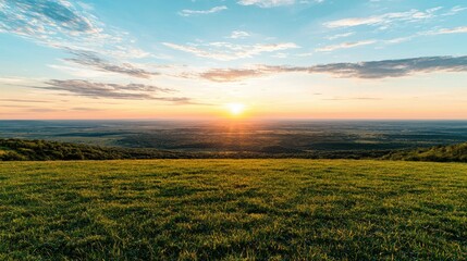 Obraz premium Sunset over grassy hilltop, panoramic view