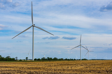 Wind turbines at the agricultural field. Clean energy. Ecological concept