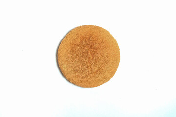 Used round brown powder puff isolated on white background.Tool for leveling powder when applying make-up.Copy space for text.Beauty care concept.For graphic design