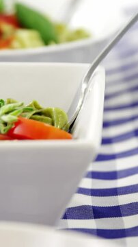 Three bowls of cooked pastas with forks