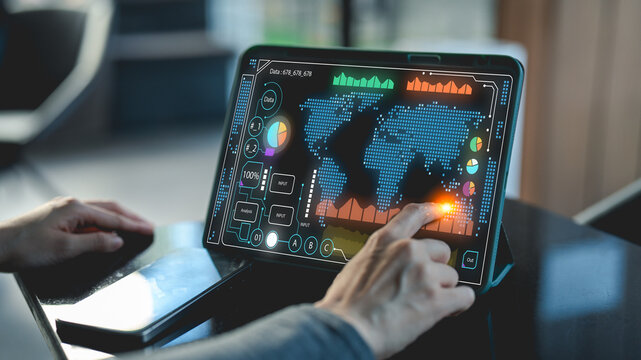 A person interacts with a digital map on a tablet, showcasing vibrant graphics and data points.