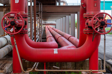 Industrial pipes and valves. Red hydrant fire fighting metal piping system