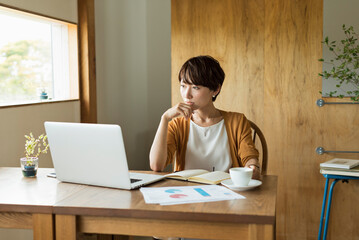 カフェで仕事をする30代女性