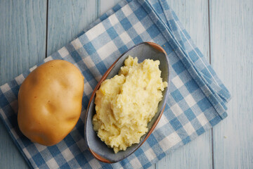 Creamy mashed potatoes served with a whole potato