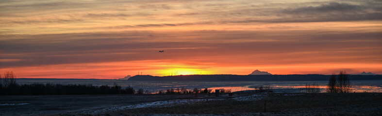 Plane flying in Sunset in Alaska
