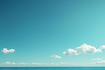 Obraz premium Tranquil Seascape: Azure Sky, Calm Ocean, and Fluffy Clouds