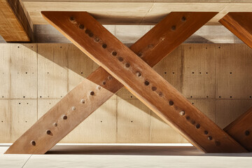 Unique architectural design featuring intersecting wooden beams and concrete structure in daylight