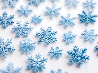 A collection of delicate icy blue snowflakes in various intricate symmetrical designs isolated on a white background, perfect for winter-themed graphics and prints.